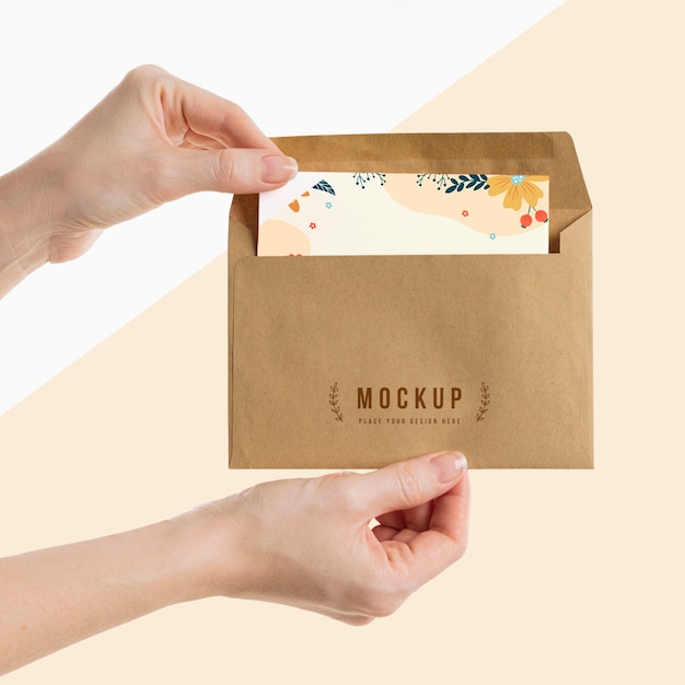 PSD hand holding an envelope mock-up