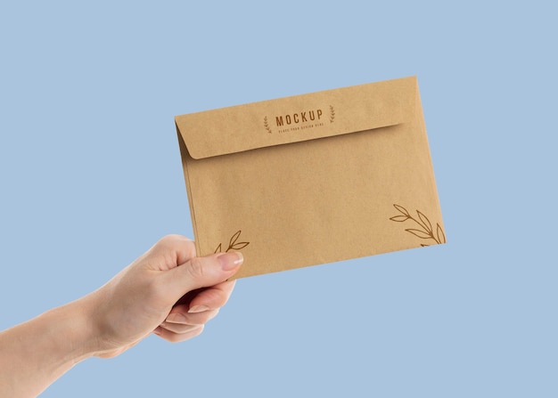 PSD hand holding an envelope mock-up