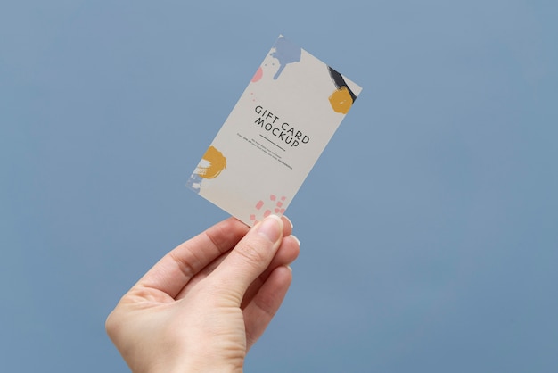 PSD hand holding gift card  mockup