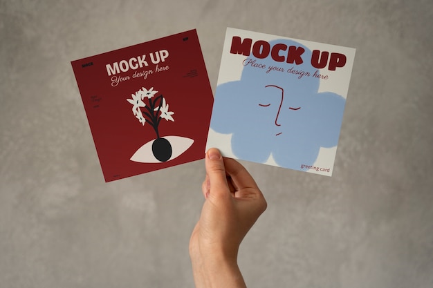 Hand holding greeting card mockup design
