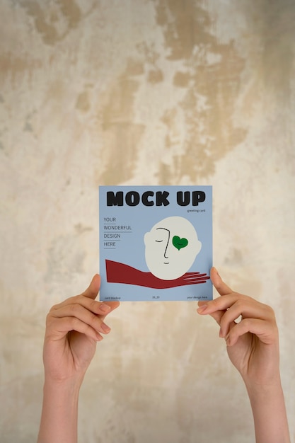 Hand holding greeting card mockup design