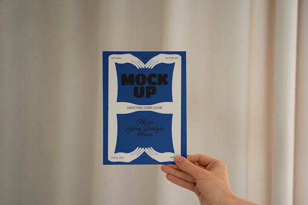Hand holding greeting card mockup design