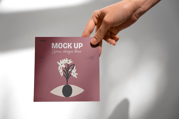 Hand holding greeting card mockup design
