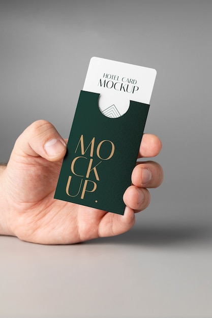 PSD hand holding hotel business card mockup