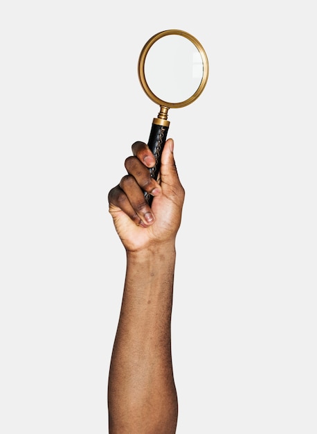 Hand holding magnifying glass