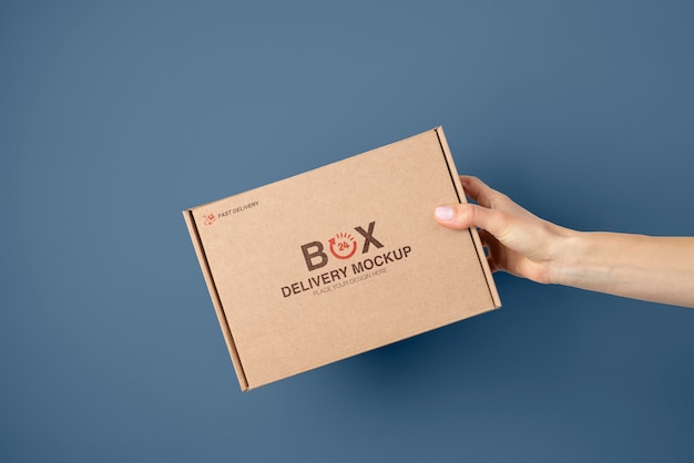 PSD hand holding mailing box mockup