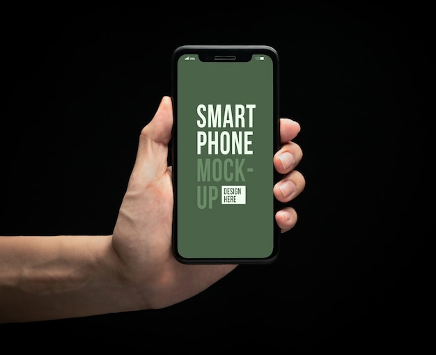 あなたのデザインの画面モックアップテンプレートと現代のスマートフォンを持っている手