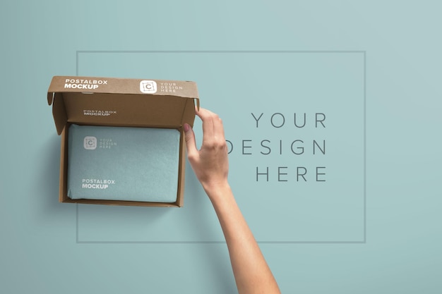 PSD hand holding opened postal box lid mockup