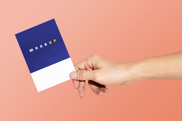 PSD hand holding a paper psd mockup