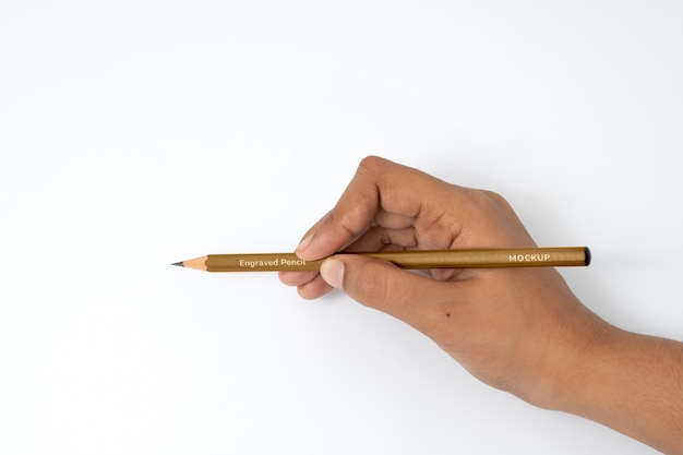 Hand holding pencil mockup