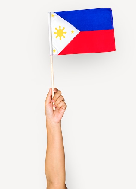 Hand holding Philippine flag isolated