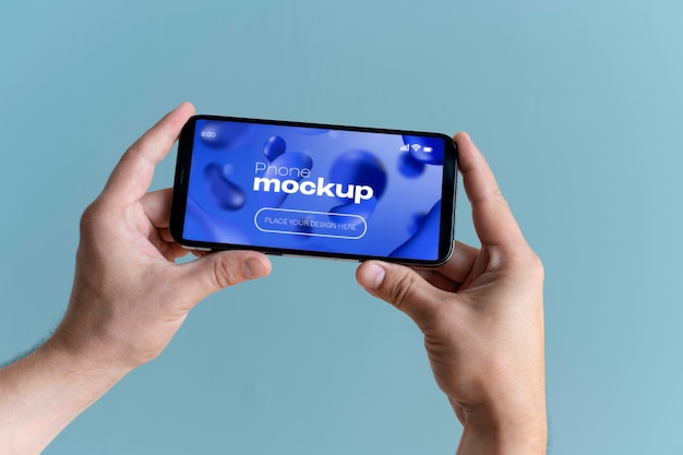 Hand holding phone screen mockup