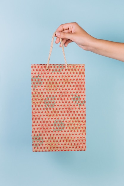 Hand holding shopping bag mockup