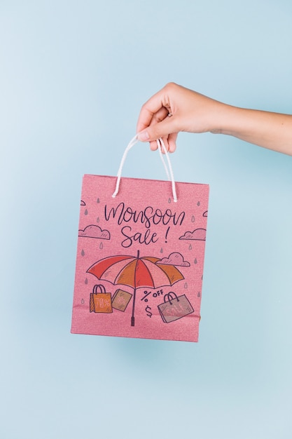 Hand holding shopping bag mockup