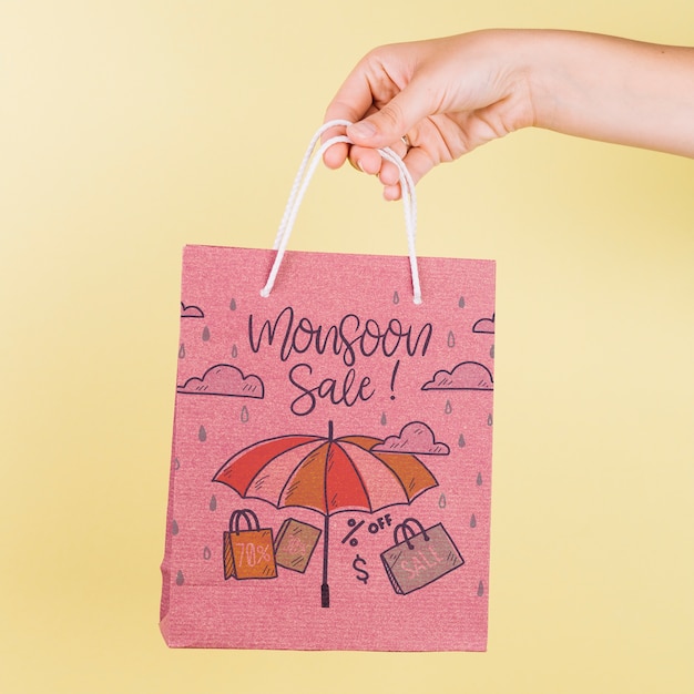 PSD hand holding shopping bag mockup