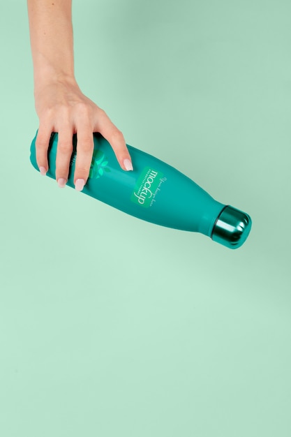 PSD hand holding thermos mockup