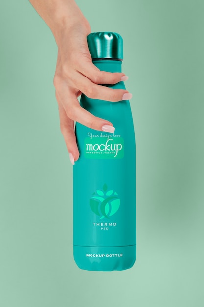 PSD hand holding thermos mockup