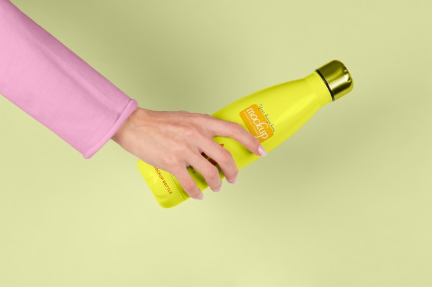 Hand holding thermos mockup