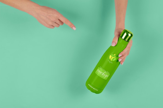 Hand holding thermos mockup