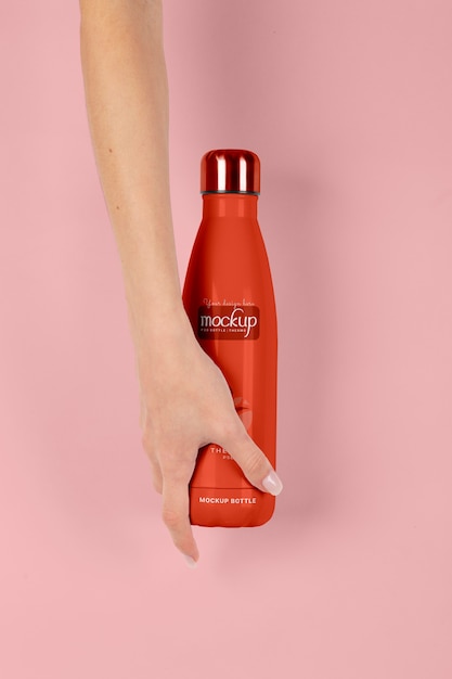 PSD hand holding thermos mockup