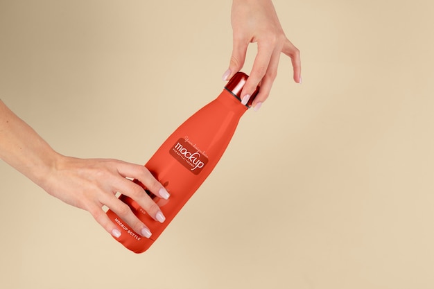 Hand holding thermos mockup