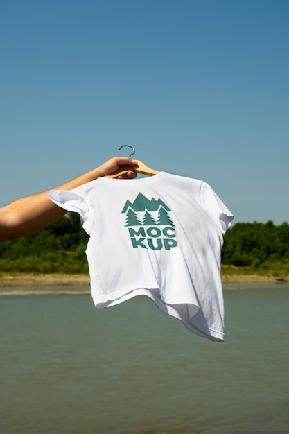 PSD hand holding tshirt in nature