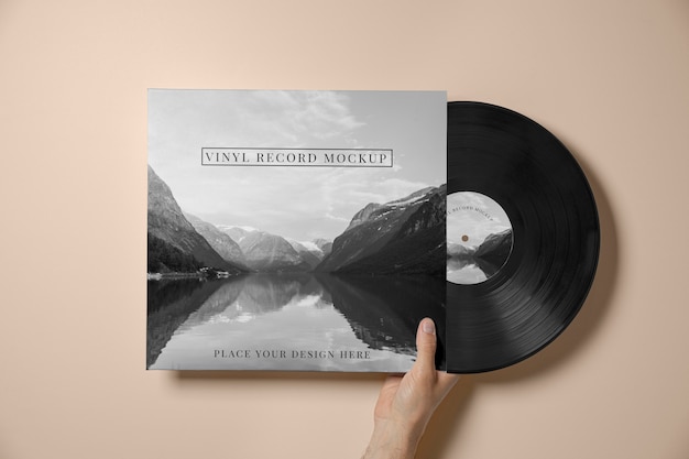 PSD hand holding vinyl record and cover