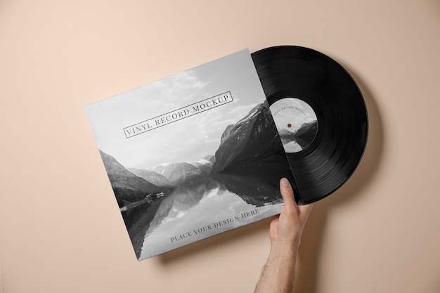 Hand holding vinyl record mockup