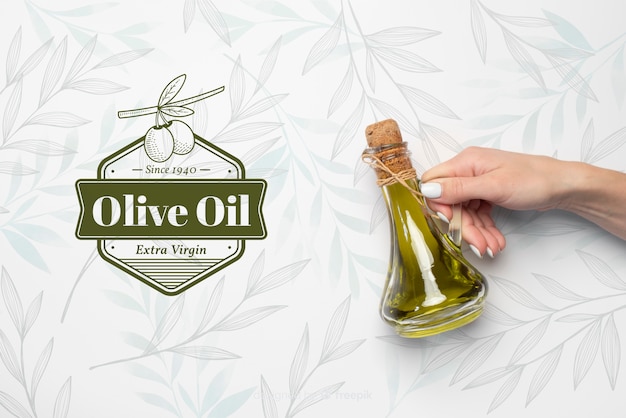 hand holding virgin olive oil