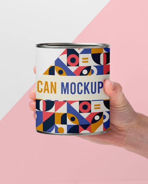 hand with tin can