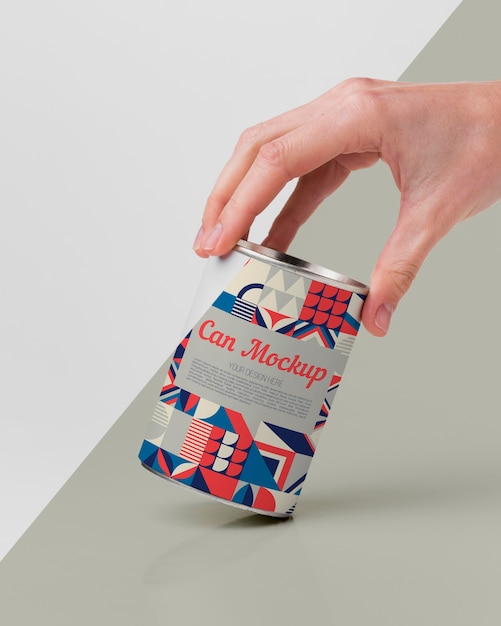 hand with tin can