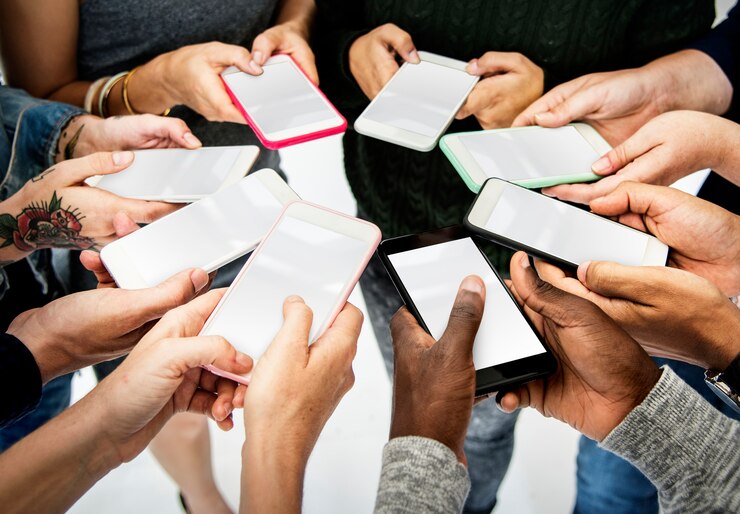 PSD hands hold blank mobile phone together copy space