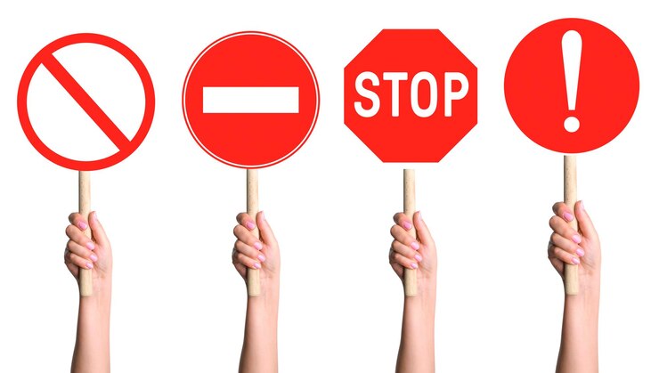 PSD hands holding a set of prohibition signs on a stick on a blank background