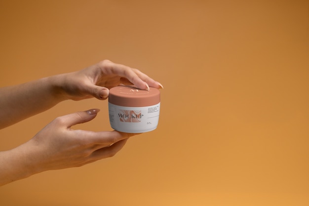 PSD hands holding apricot color beauty cream