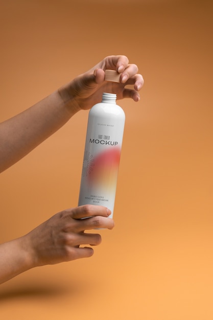 Hands holding apricot color beauty cream