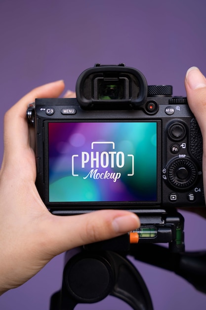 PSD hands holding camera with purple background