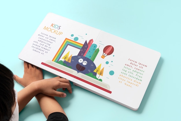 Hands holding children book mockup