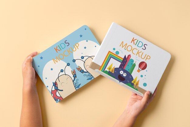 Hands holding children book mockup