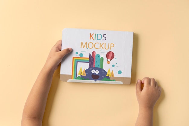 PSD hands holding children book mockup