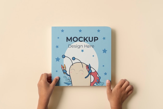 PSD hands holding children book mockup