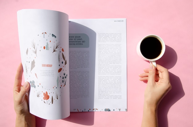 Hands holding a magazine and a cup of coffee mock up