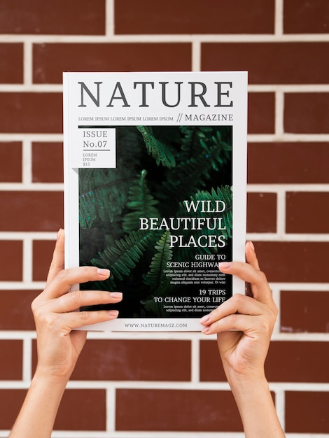 Hands holding a nature magazine mock up