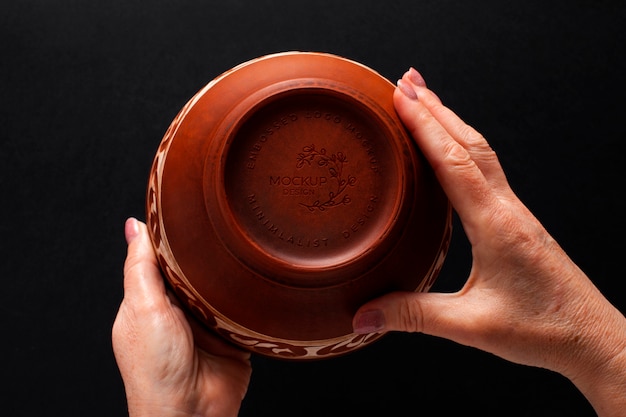 PSD hands holding porcelain with logo mockup