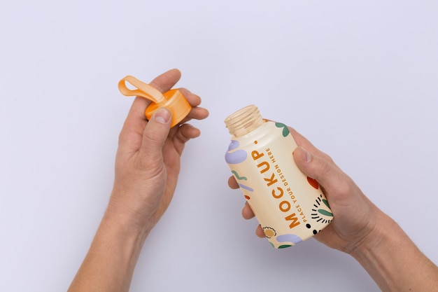 Hands holding reusable bottle top view