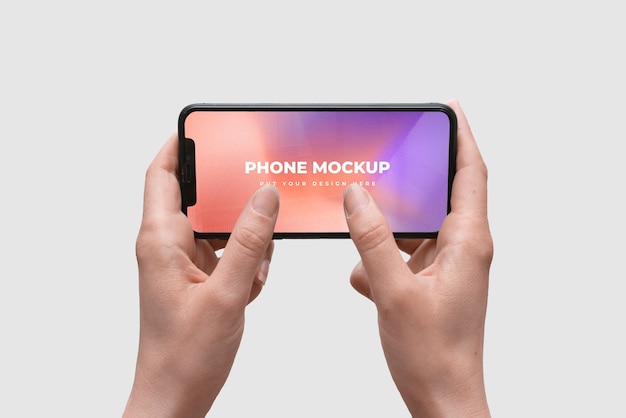 Hands holding smartphone device mock-up on color background