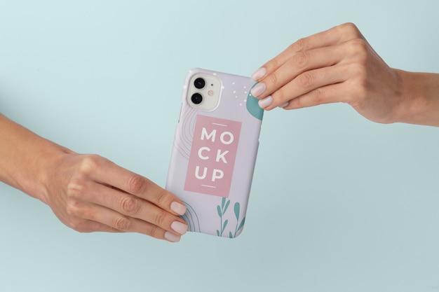 Hands holding smartphone with mock-up phone case