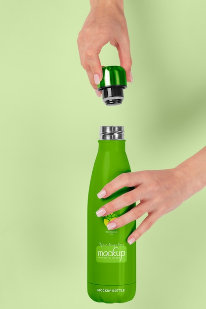 Hands holding thermos mockup