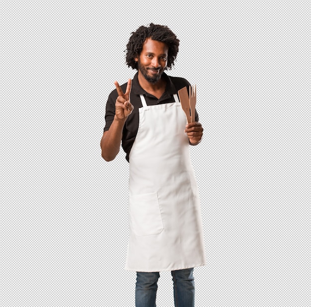 Handsome african american baker fun and happy, positive and natural, makes a gesture of victory, peace concept