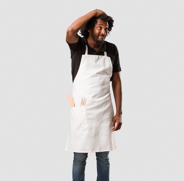 PSD handsome african american baker worried and overwhelmed, forgetful, realize something, expression of shock at having made a mistake