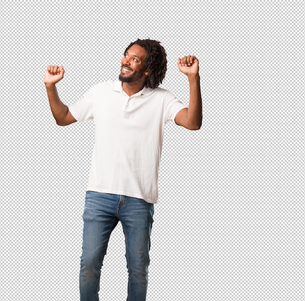 handsome african american listening to music, dancing and having fun, moving, shouting and expressing happiness, freedom concept